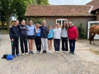 A group of students from the Downe House School standing near the Wyld Court stables.
