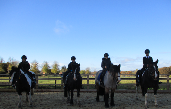 Four Trinity School riders on their ponies at Wyld Court